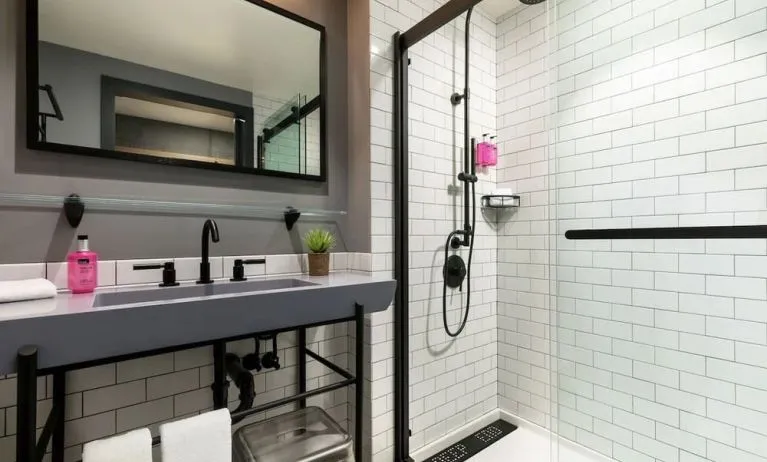Private guest bathroom with shower at Moxy Boston Downtown.