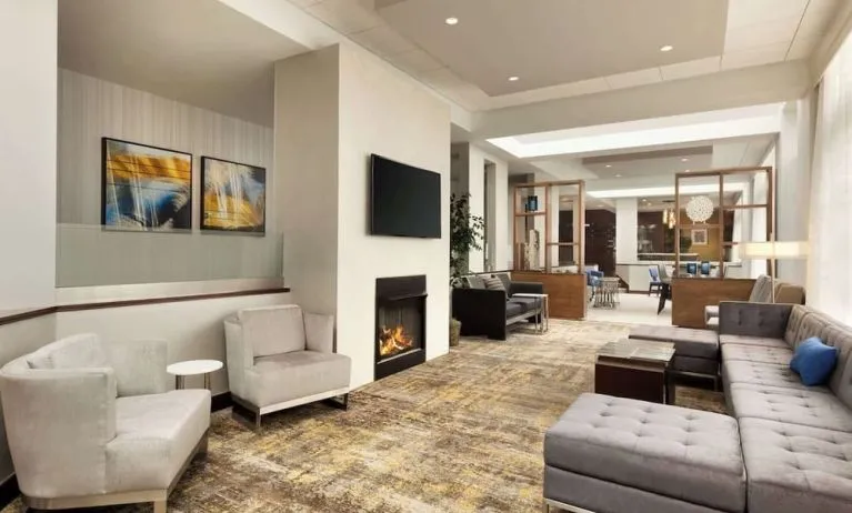 Lobby lounge area with fireplace at DoubleTree By Hilton Hartford - Bradley Airport.