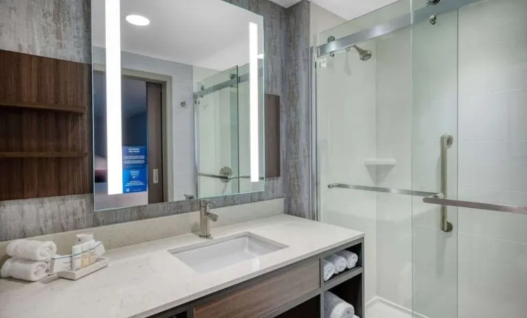 Private guest bathroom with shower at Hilton Garden Inn Boston Logan Airport.