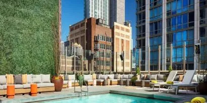 Stunning outdoor pool surrounded by skyscrapers at Royalton Park Avenue.