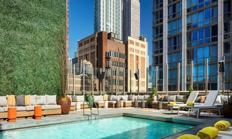 Stunning outdoor pool surrounded by skyscrapers at Royalton Park Avenue.