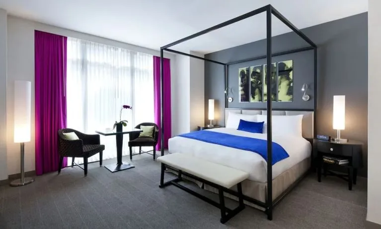 King bedroom with seating area and natural light at Royalton Park Avenue.