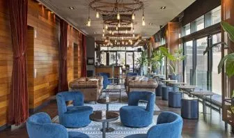 Lounge and coworking area beside elevators at Royalton Park Avenue.
