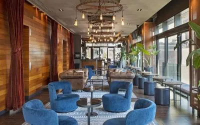 Lounge and coworking area beside elevators at Royalton Park Avenue.
