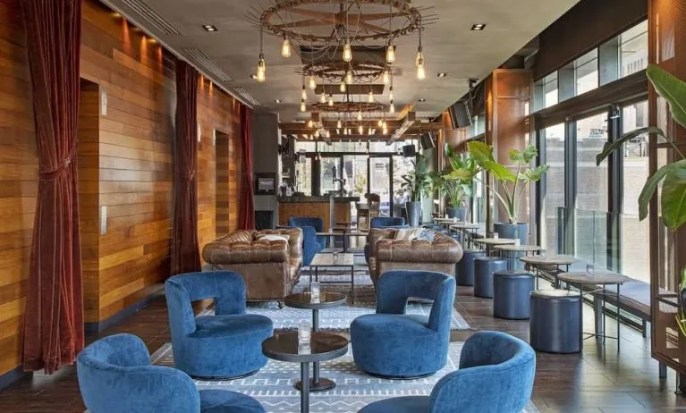 Lounge and coworking area beside elevators at Royalton Park Avenue.
