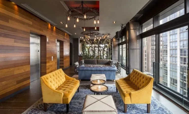 Lounge and coworking area beside elevators at Royalton Park Avenue.