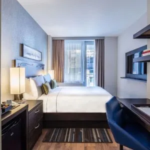 Day use room with work desk and balcony at The Bernic Hotel New York City, Tapestry Collection By Hilton.
