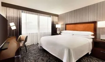 Delux king room with TV and work desk at Embassy Suites By Hilton Santa Clara Silicon Valley.