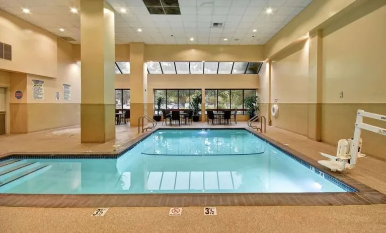 Relaxing indoor pool with seating area at Embassy Suites By Hilton Santa Clara Silicon Valley.