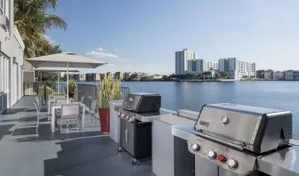 Grill and picnic area with a great view of the lagoon at Homewood Suites By Hilton Miami Airport-Blue Lagoon.