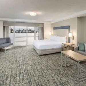 Spacious day use room with sofa and a view of the Blue Lagoon at Homewood Suites By Hilton Miami Airport-Blue Lagoon.