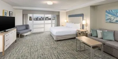 Spacious day use room with sofa and a view of the Blue Lagoon at Homewood Suites By Hilton Miami Airport-Blue Lagoon.