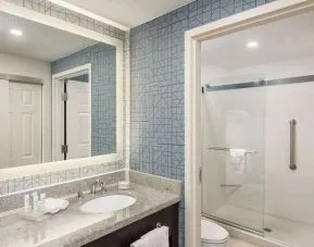 Guest bathroom with shower at Homewood Suites By Hilton Miami Airport-Blue Lagoon.