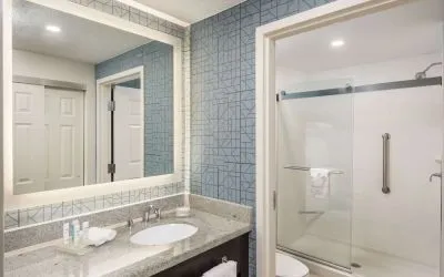 Guest bathroom with shower at Homewood Suites By Hilton Miami Airport-Blue Lagoon.