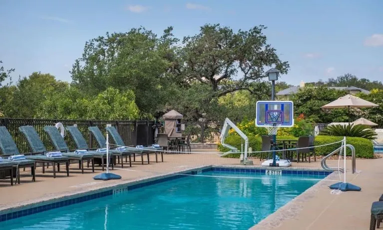 One of the 3 outdoor pools with loungers at Hilton San Antonio Hill Country.
