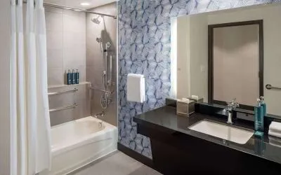 Guest bathroom with shower and tub at Hilton San Antonio Hill Country.
