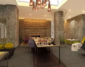 Lobby lounge and workspace with coffee service and fireplace at Hilton Garden Inn New York/Manhattan-Midtown East.