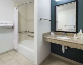 Private guest bathroom with combined shower and tub at Hilton Garden Inn Dothan.
