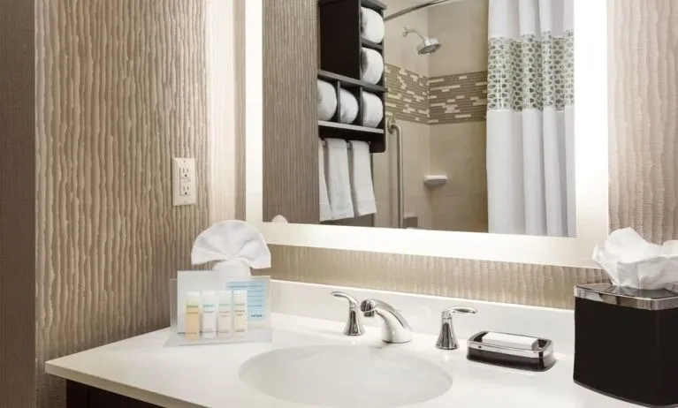 Private guest bathroom with shower and free toiletries at Hampton Inn Manhattan/Times Square Central.