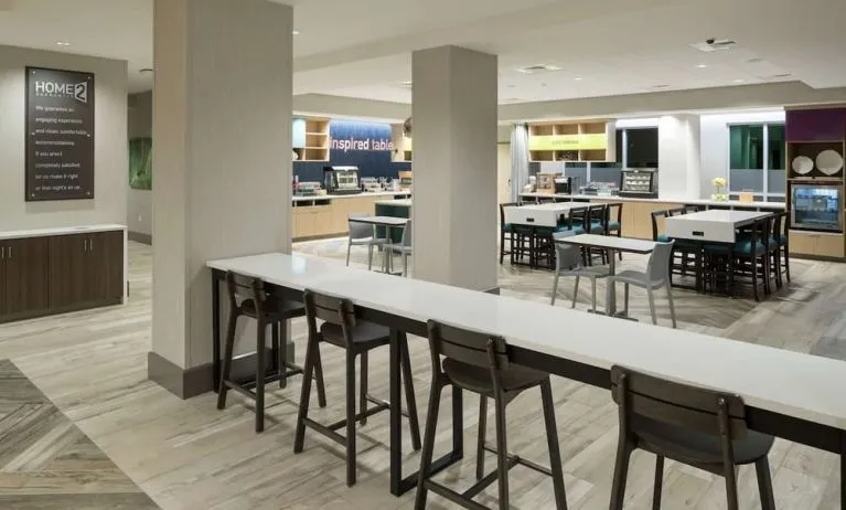 Dining area and workspace at Home2 Suites By Hilton Cape Canaveral Cruise Port.