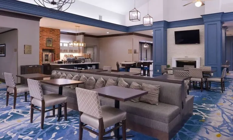Dining area with comfortable seating, perfect for coworking at Homewood Suites By Hilton Dallas-Lewisville.