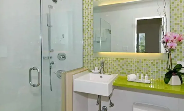 Private guest bathroom with shower and free toiletries at Circa 39 Hotel.