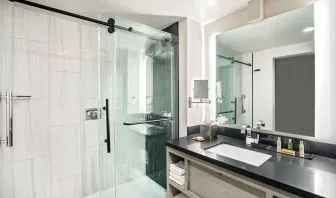 Private guest bathroom with shower and free toiletries at DoubleTree By Hilton Washington DC North/Gaithersburg.
