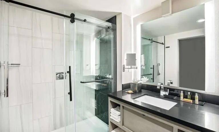 Private guest bathroom with shower and free toiletries at DoubleTree By Hilton Washington DC North/Gaithersburg.