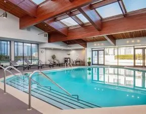 Relaxing indoor pool with lounge chairs at DoubleTree By Hilton Washington DC North/Gaithersburg.