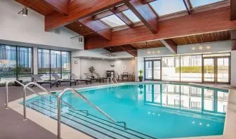 Relaxing indoor pool with lounge chairs at DoubleTree By Hilton Washington DC North/Gaithersburg.