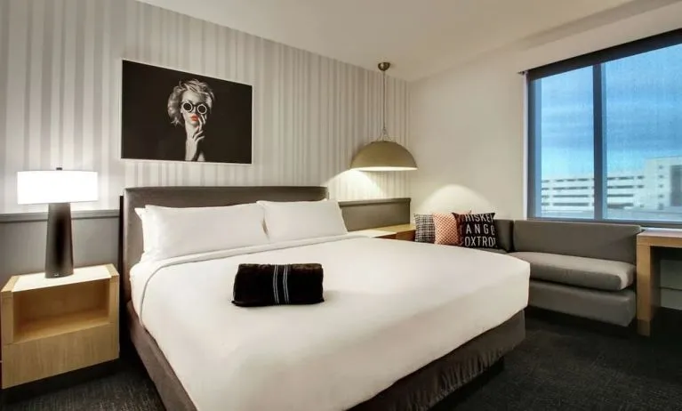 Day use room with sofa and work desk at The Rose Hotel Chicago O’Hare, Tapestry Collection By Hilton.