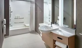Private guest bathroom with combined shower and tub at 	SpringHill Suites Atlanta Northwest.