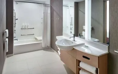 Private guest bathroom with combined shower and tub at 	SpringHill Suites Atlanta Northwest.