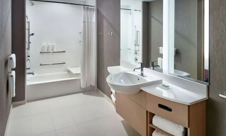 Private guest bathroom with combined shower and tub at 	SpringHill Suites Atlanta Northwest.