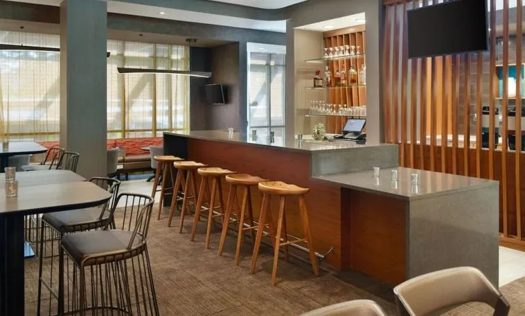 On-site bar with lounge seating and workspace, perfect for coworking at 	SpringHill Suites Atlanta Northwest.