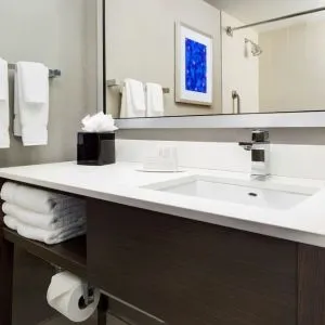 Private guest bathroom with shower and free toiletries at Courtyard Boston Cambridge.