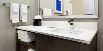 Private guest bathroom with shower and free toiletries at Courtyard Boston Cambridge.