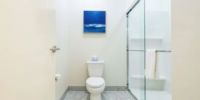 Private guest bathroom with shower and free toiletries at Palace Inn Blue IAH East.