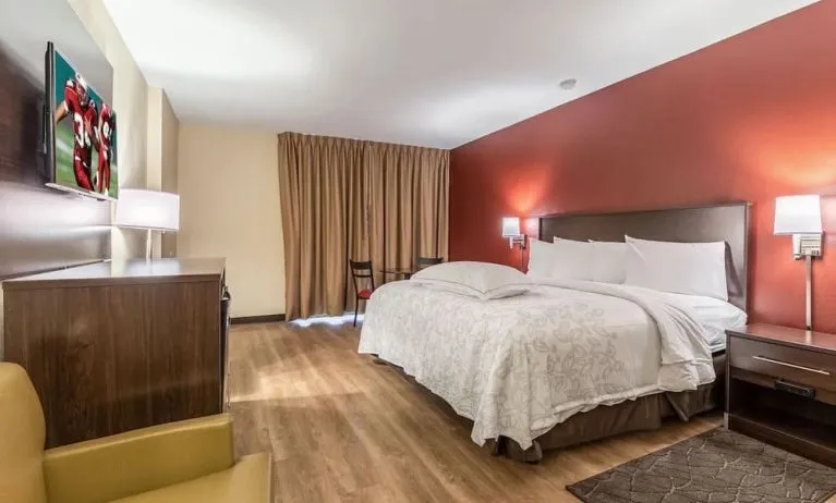 Day use room with king bed and workspace at Red Roof PLUS+ & Suites Houston - IAH Airport SW.