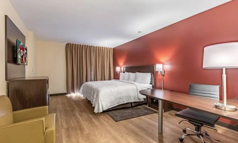 Spacious delux king bedroom with work desk at Red Roof PLUS+ & Suites Houston - IAH Airport SW.