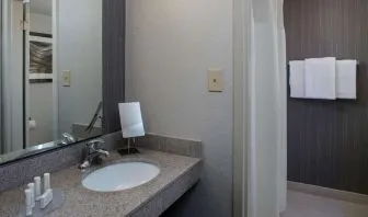 Private guest bathroom with shower and free toiletries at Sonesta Select Atlanta Norcross I-85.