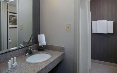 Private guest bathroom with shower and free toiletries at Sonesta Select Atlanta Norcross I-85.