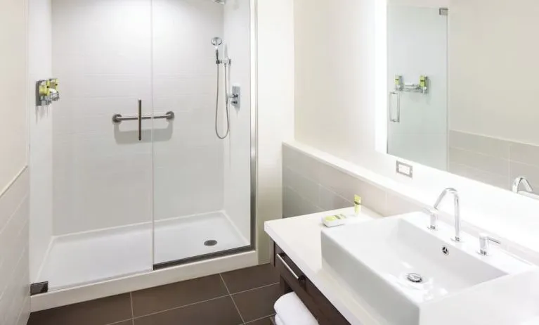 Private guest bathroom with shower and free toiletries at Element Miami International Airport.