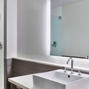 Private guest bathroom with shower at Element Miami International Airport.