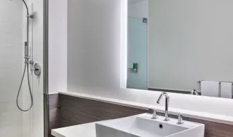 Private guest bathroom with shower at Element Miami International Airport.