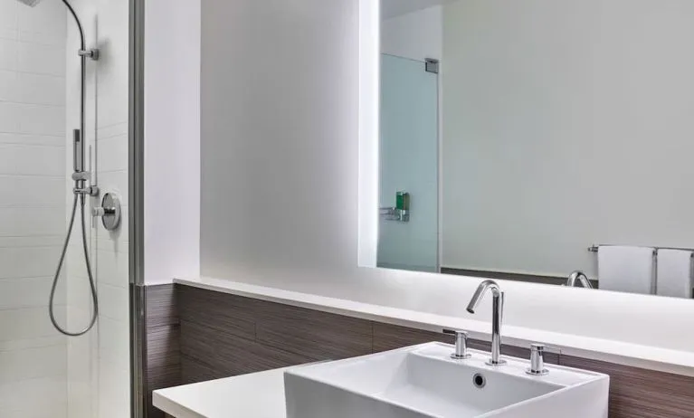 Private guest bathroom with shower at Element Miami International Airport.