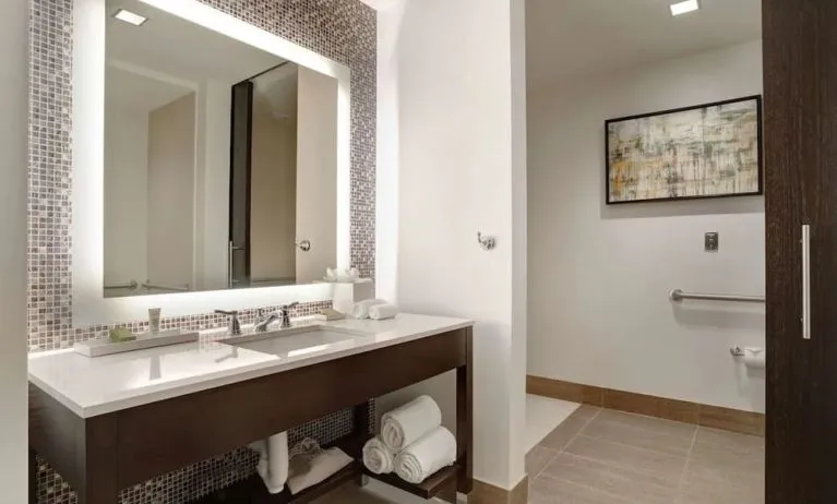 Private guest bathroom with free toiletries at Hilton Dallas/ Plano Granite Park.