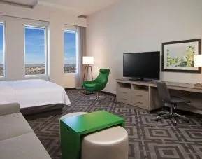 Day use room with work desk and sofa at Homewood Suites By Hilton LAX Airport.