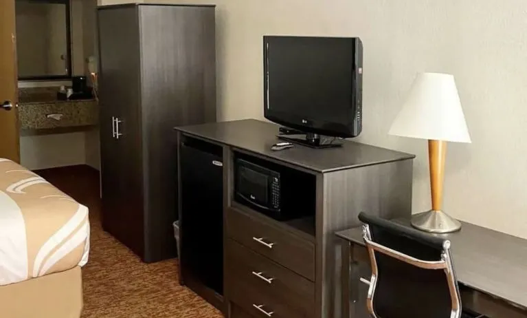 TV and work desk at Hibiscus Inn & Suites.
