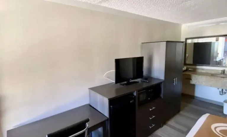 Desk and TV at Hibiscus Inn & Suites.